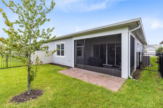 2302 Datura Loop, Saint Cloud, FL 34772 - rear view of house featuring a sunroom, a fenced backyard, and stucco siding