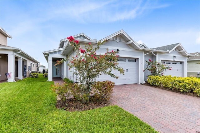 2302 Datura Loop, Saint Cloud, FL 34772 - view of front of home featuring a front lawn, decorative driveway, a garage, and stucco siding