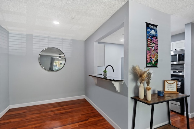 2035 Dixie Belle Dr Unit 2035C, Orlando, FL 32812 - bar with appliances with stainless steel finishes, wood finished floors, a textured ceiling, and recessed lighting