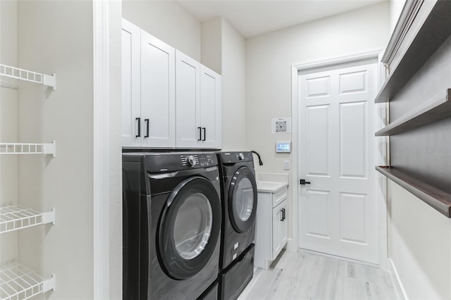 18623 Tunbridge St, Orlando, FL 32833 - laundry room with independent washer and dryer, cabinet space, and light wood-style floors