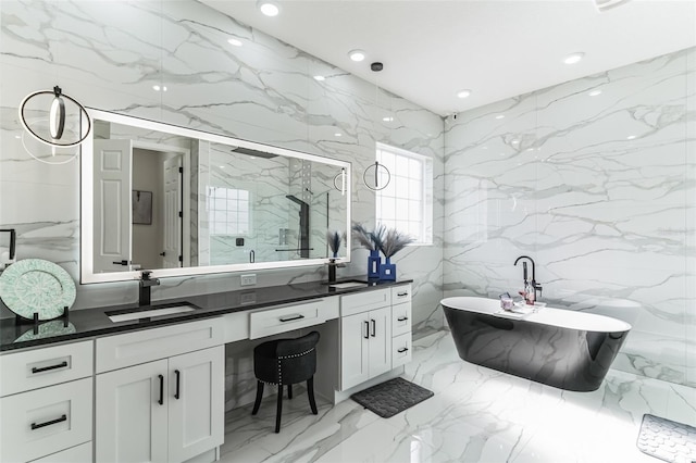 18623 Tunbridge St, Orlando, FL 32833 - full bath featuring double vanity, marble tiled floors, a marble finish shower, a soaking tub, and tile walls