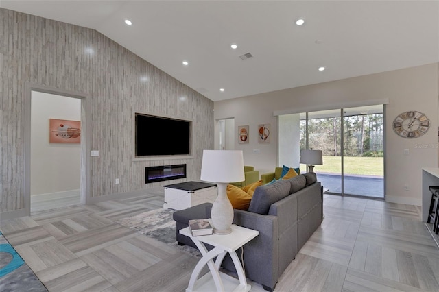 18623 Tunbridge St, Orlando, FL 32833 - living area with vaulted ceiling, a glass covered fireplace, an accent wall, and recessed lighting