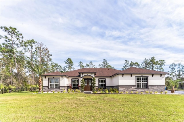 18623 Tunbridge St, Orlando, FL 32833 - view of front of home with stone siding, stucco siding, and a front yard