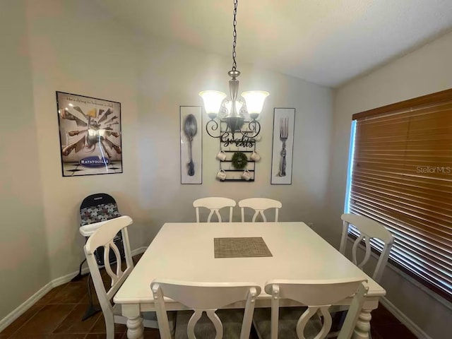 8071 Roaring Creek Ct, Kissimmee, FL 34747 - dining room with a chandelier, dark tile patterned flooring, and vaulted ceiling