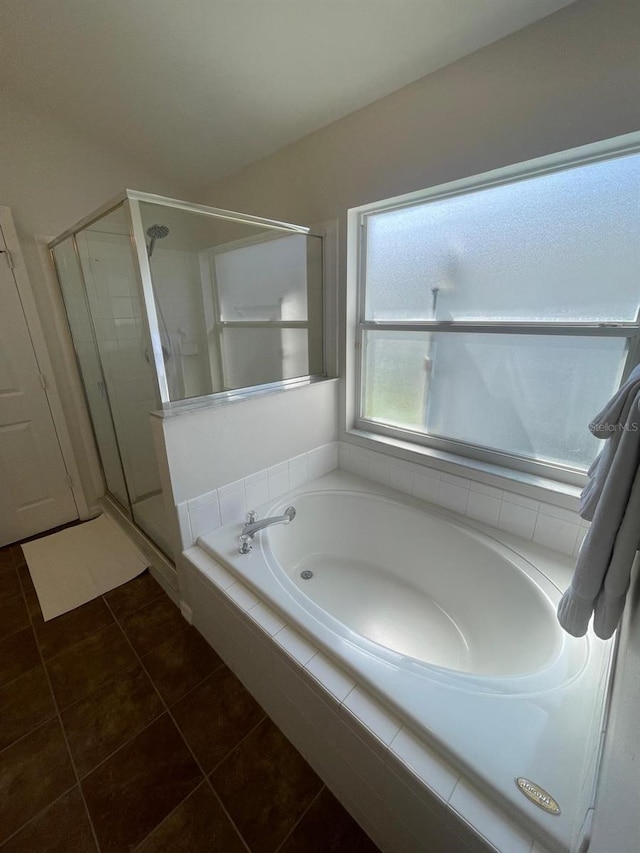 8071 Roaring Creek Ct, Kissimmee, FL 34747 - bathroom featuring a shower stall, a garden tub, and tile patterned floors