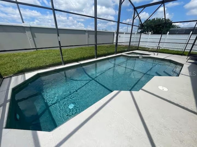 8071 Roaring Creek Ct, Kissimmee, FL 34747 - view of pool featuring a fenced backyard, glass enclosure, a patio, and a pool with connected hot tub