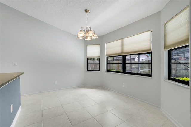 1173 Trotwood Blvd, Winter Springs, FL 32708 - unfurnished dining area featuring a chandelier, a textured ceiling, and light tile patterned flooring