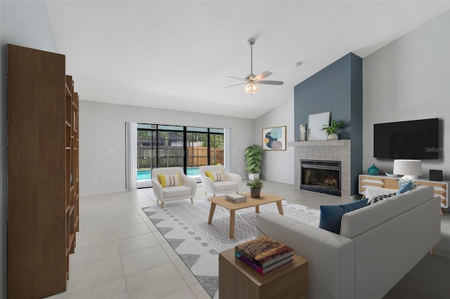 1173 Trotwood Blvd, Winter Springs, FL 32708 - living room with a ceiling fan, a fireplace, light tile patterned floors, a textured ceiling, and high vaulted ceiling