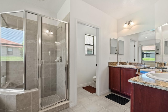 2982 Camino Real Dr S, Kissimmee, FL 34744 - bathroom with two vanities, a shower stall, and tile patterned floors