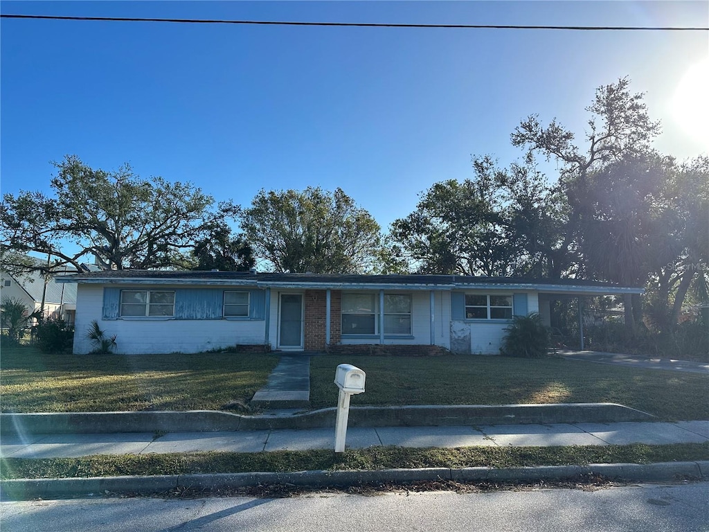 3036 Dixie Ave, Sarasota, FL 34234 - ranch-style house featuring a front lawn