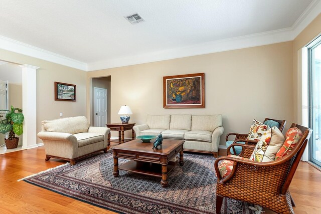 6631 Crestmont Glen Ln, Windermere, FL 34786 - living area with crown molding, wood finished floors, and ornate columns