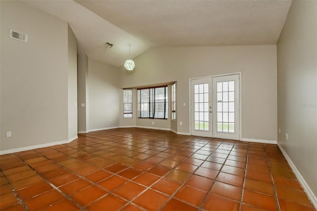 3703 43rd Ave W, Bradenton, FL 34205 - spare room with tile patterned flooring, plenty of natural light, high vaulted ceiling, and a textured ceiling