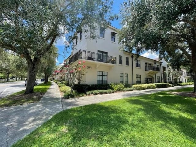 949 Westpark Dr Unit 107, Celebration, FL 34747 - view of property exterior featuring a yard and stucco siding