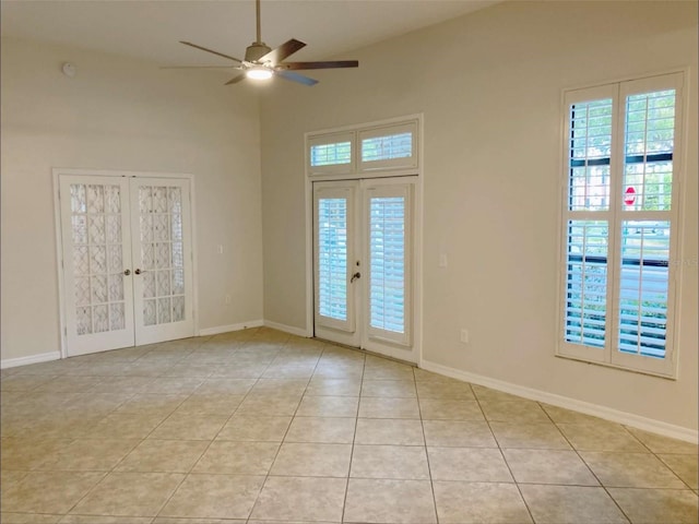 949 Westpark Dr Unit 107, Celebration, FL 34747 - spare room with french doors, a ceiling fan, light tile patterned floors, and a towering ceiling