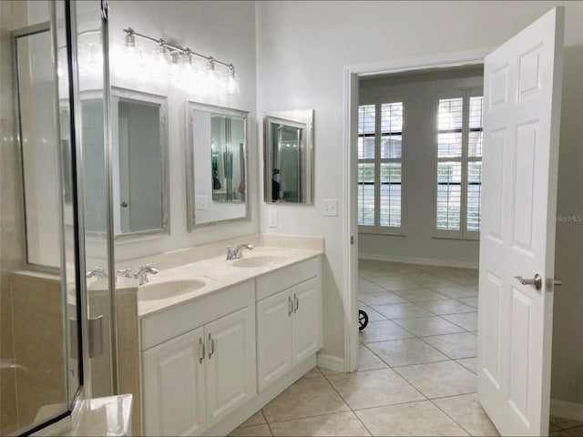 949 Westpark Dr Unit 107, Celebration, FL 34747 - full bathroom featuring double vanity, tile patterned flooring, plenty of natural light, and a shower with shower door