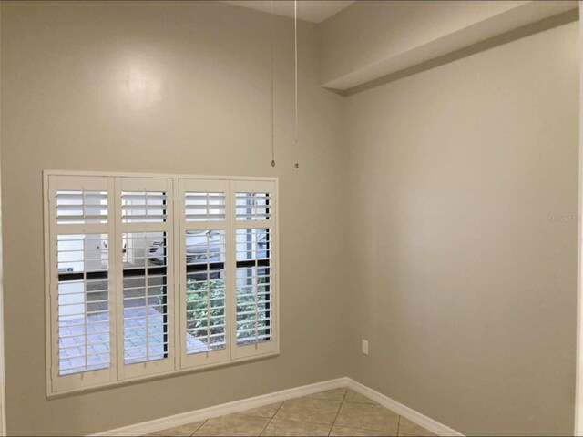 949 Westpark Dr Unit 107, Celebration, FL 34747 - empty room with light tile patterned floors and baseboards
