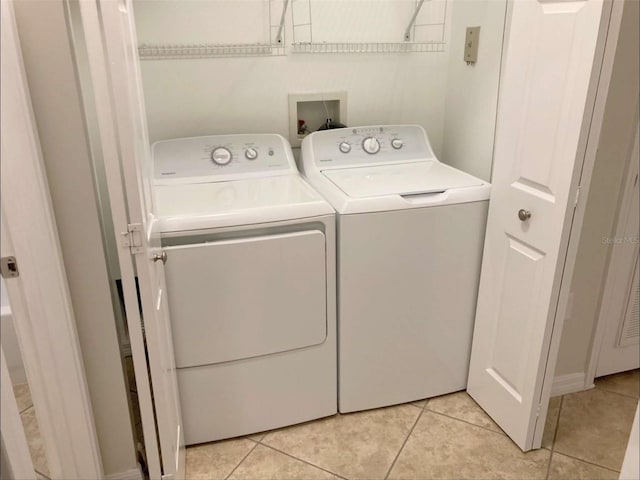 949 Westpark Dr Unit 107, Celebration, FL 34747 - washroom featuring washing machine and dryer and light tile patterned floors