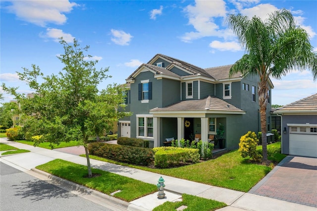 10180 Merrymeeting Bay Dr, Winter Garden, FL 34787 - view of front of property with stucco siding, decorative driveway, a garage, and a tile roof