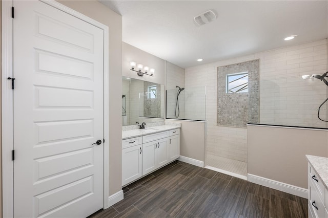 10180 Merrymeeting Bay Dr, Winter Garden, FL 34787 - bathroom featuring vanity, a walk in shower, wood finish floors, and recessed lighting