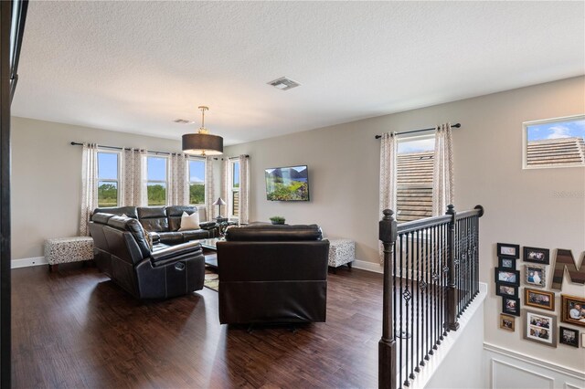 10180 Merrymeeting Bay Dr, Winter Garden, FL 34787 - living room featuring dark wood finished floors and a textured ceiling