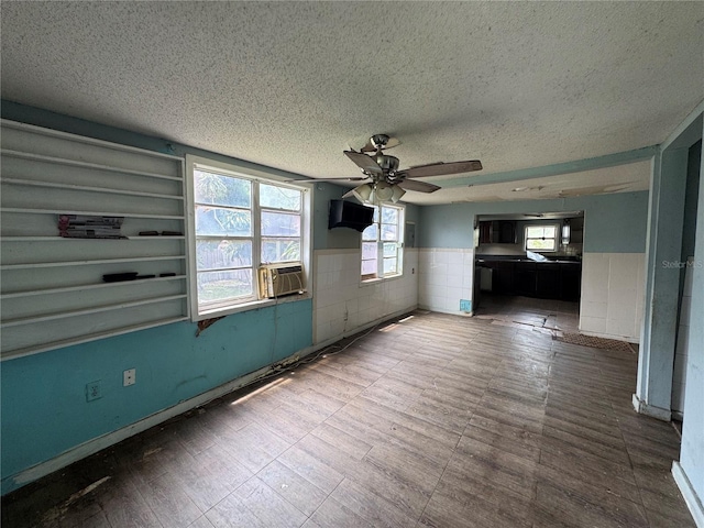 269 12th Ave, Ocoee, FL 34761 - unfurnished room featuring wainscoting, a textured ceiling, ceiling fan, and cooling unit