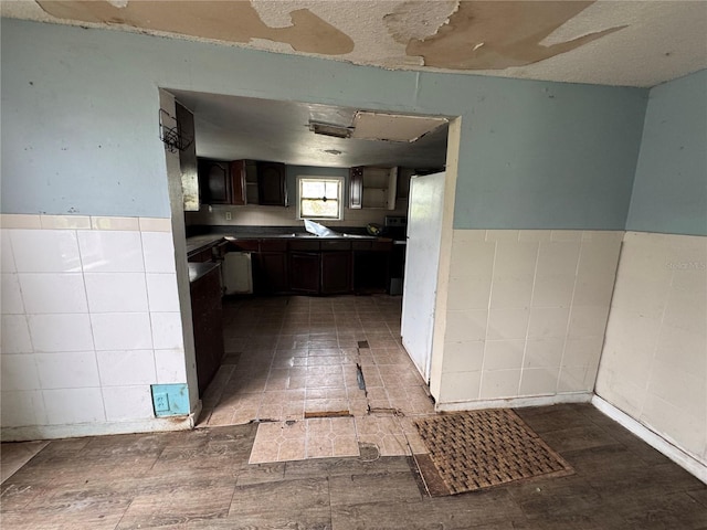 269 12th Ave, Ocoee, FL 34761 - kitchen with tile walls, a wainscoted wall, and dark countertops