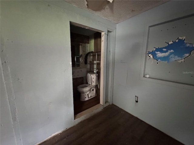 269 12th Ave, Ocoee, FL 34761 - unfurnished bedroom with dark wood finished floors and a textured ceiling
