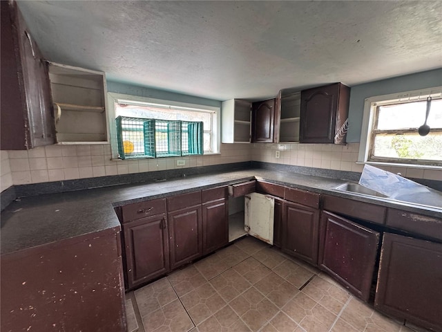 269 12th Ave, Ocoee, FL 34761 - kitchen with open shelves, dark countertops, plenty of natural light, and a textured ceiling