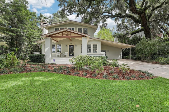 213 Phillips Pl, Orlando, FL 32806 - view of front facade featuring driveway, a chimney, a front lawn, and a porch