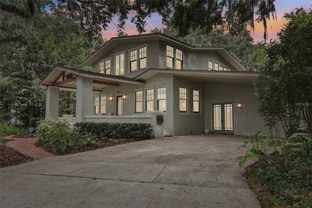 213 Phillips Pl, Orlando, FL 32806 - back of house with stucco siding, driveway, and french doors