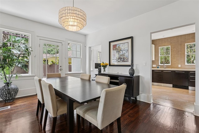 213 Phillips Pl, Orlando, FL 32806 - dining area featuring a chandelier and hardwood / wood-style floors