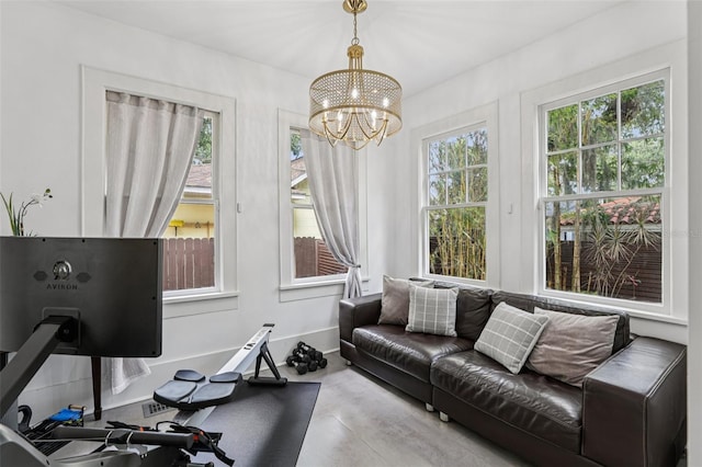 213 Phillips Pl, Orlando, FL 32806 - workout area featuring a chandelier and baseboards