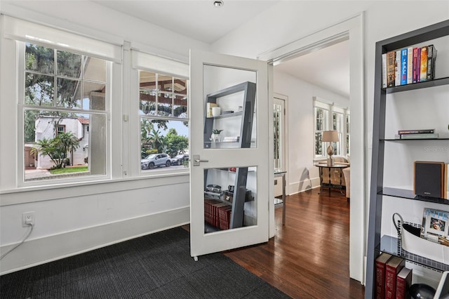 213 Phillips Pl, Orlando, FL 32806 - doorway with dark wood-style flooring and baseboards