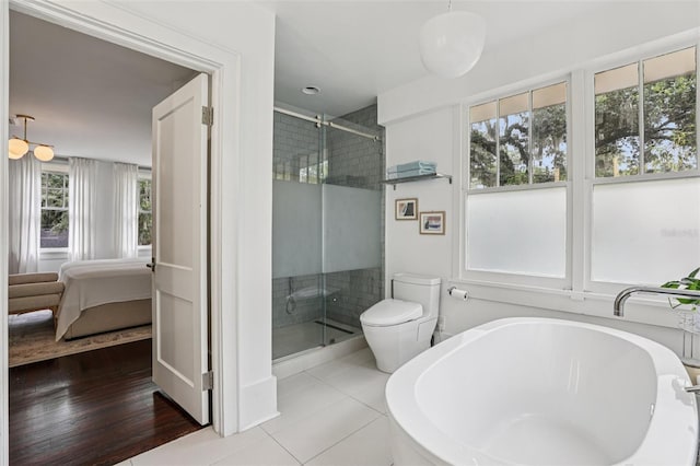 213 Phillips Pl, Orlando, FL 32806 - bathroom featuring ensuite bathroom, a shower stall, a soaking tub, and tile patterned flooring