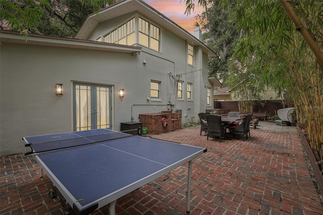 213 Phillips Pl, Orlando, FL 32806 - patio terrace at dusk with a patio area, outdoor dining area, and french doors