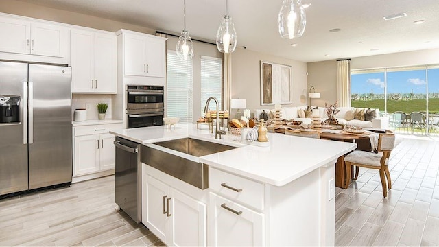 5277 Bowspirit Way, Saint Cloud, FL 34771 - kitchen featuring stainless steel appliances, light countertops, light wood-style flooring, hanging light fixtures, and recessed lighting