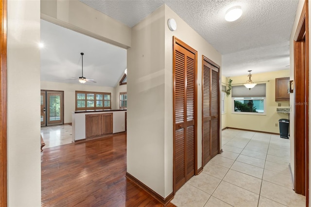 3310 Tall Timber Dr, Orlando, FL 32812 - corridor featuring light wood-style flooring and a textured ceiling