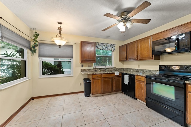 3310 Tall Timber Dr, Orlando, FL 32812 - kitchen with black appliances, brown cabinetry, ceiling fan, pendant lighting, and a textured ceiling