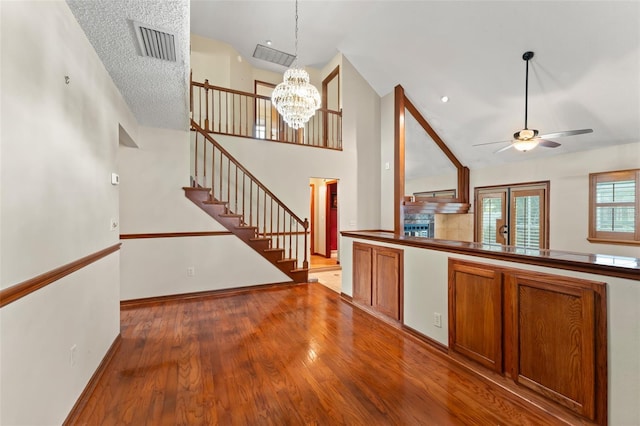 3310 Tall Timber Dr, Orlando, FL 32812 - kitchen with brown cabinets, ceiling fan, a chandelier, wood finished floors, and hanging light fixtures