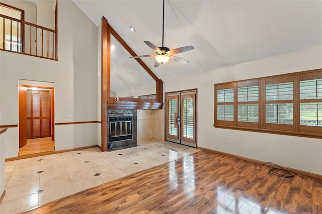 3310 Tall Timber Dr, Orlando, FL 32812 - unfurnished living room featuring wood finished floors, a ceiling fan, high vaulted ceiling, a fireplace, and french doors