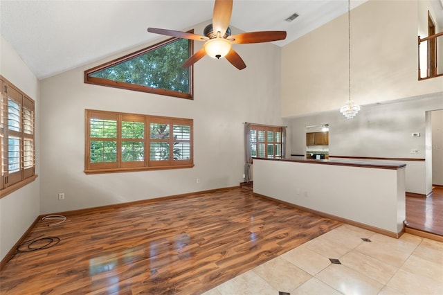3310 Tall Timber Dr, Orlando, FL 32812 - unfurnished living room with high vaulted ceiling, ceiling fan, and wood finished floors