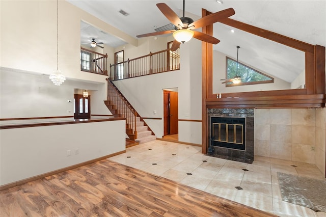 3310 Tall Timber Dr, Orlando, FL 32812 - unfurnished living room with a ceiling fan, high vaulted ceiling, beam ceiling, stairs, and wood finished floors