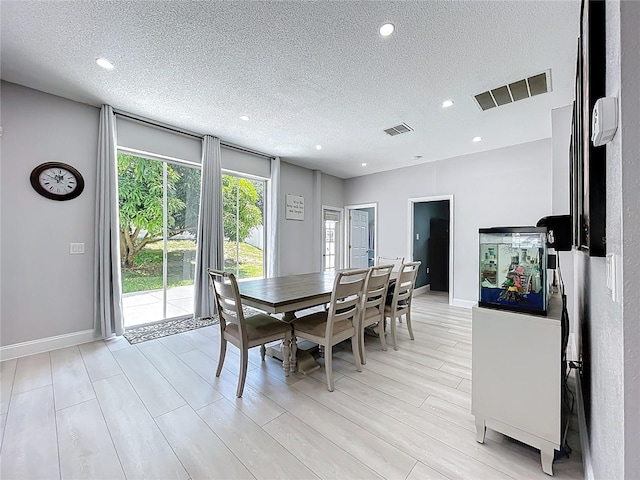 238 Hunt St, Clermont, FL 34711 - dining area featuring a textured ceiling, recessed lighting, and light wood-type flooring