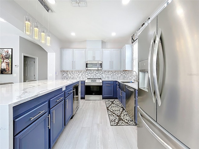 238 Hunt St, Clermont, FL 34711 - kitchen with stainless steel appliances, blue cabinetry, backsplash, beverage cooler, and recessed lighting