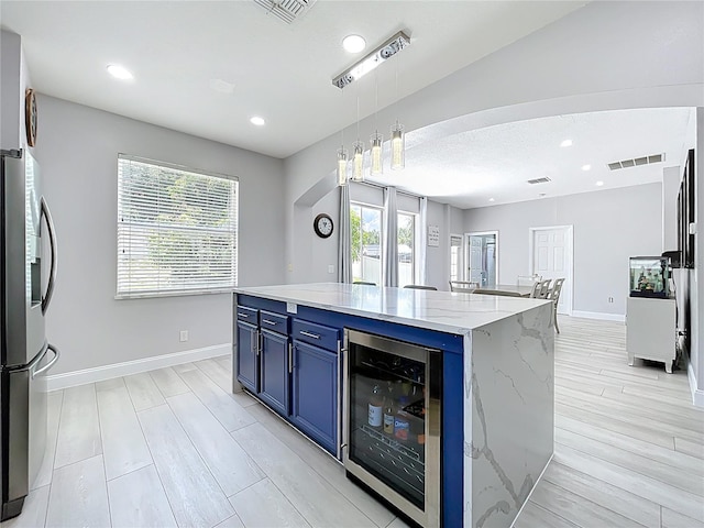 238 Hunt St, Clermont, FL 34711 - kitchen with wine cooler, blue cabinets, light wood-type flooring, recessed lighting, and stainless steel refrigerator with ice dispenser