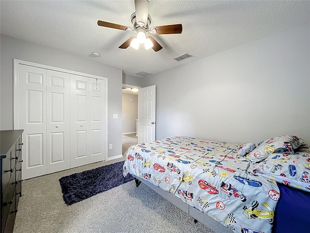 238 Hunt St, Clermont, FL 34711 - carpeted bedroom with a closet, a textured ceiling, and a ceiling fan