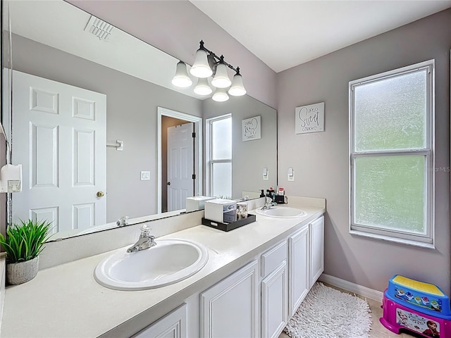 238 Hunt St, Clermont, FL 34711 - bathroom with double vanity and baseboards