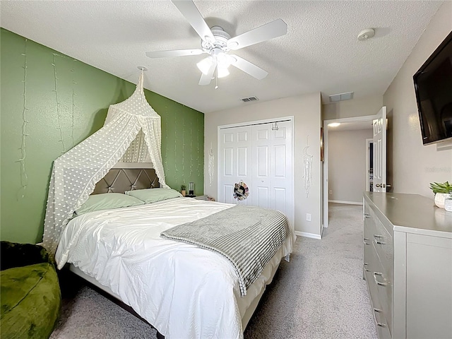 238 Hunt St, Clermont, FL 34711 - bedroom featuring light carpet, a closet, a ceiling fan, and a textured ceiling