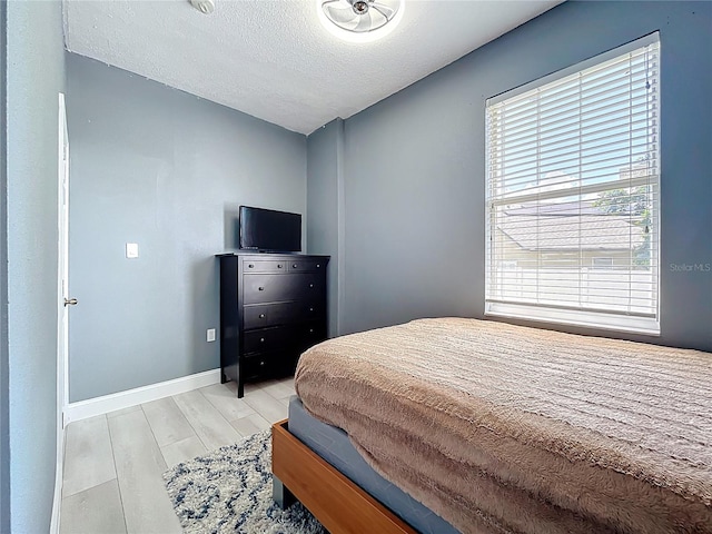 238 Hunt St, Clermont, FL 34711 - bedroom with wood finished floors and a textured ceiling