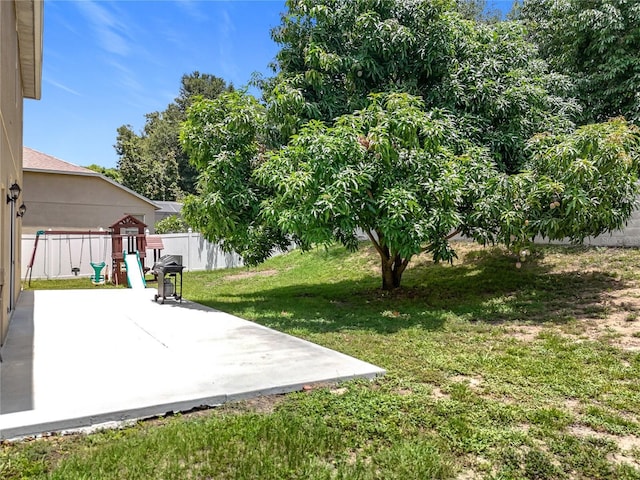 238 Hunt St, Clermont, FL 34711 - fenced backyard featuring a patio and a playground